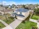 Aerial view of home with a large driveway and mature landscaping at 9518 Lynwood St, Clermont, FL 34711