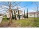 Large backyard with a private patio, mature landscaping, and a partial fence, perfect for outdoor entertaining at 9518 Lynwood St, Clermont, FL 34711