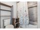 Cozy bathroom with a decorative shower curtain and dark wood shelving at 9518 Lynwood St, Clermont, FL 34711