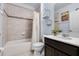 Well-lit bathroom featuring a bathtub with tiled walls and a sleek, modern vanity at 9518 Lynwood St, Clermont, FL 34711