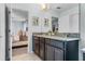 Bright bathroom with granite countertop double sinks and decorative mirrors at 9518 Lynwood St, Clermont, FL 34711