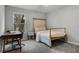 Bright bedroom with carpet flooring, a cozy bed, a study desk, and a bright window, great for relaxation at 9518 Lynwood St, Clermont, FL 34711