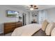 Bedroom with a dresser, TV, and bright natural light from windows at 9518 Lynwood St, Clermont, FL 34711
