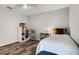 Well-lit bedroom with light-colored walls, hardwood floors, and cozy furnishings, with a window at 9518 Lynwood St, Clermont, FL 34711