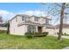 Charming home with a two-car garage, neutral colored exterior, stone accents, and a brick paver driveway at 9518 Lynwood St, Clermont, FL 34711