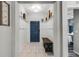 Welcoming foyer with white wainscotting, tile flooring, and a stylish bench at 9518 Lynwood St, Clermont, FL 34711