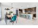 Open-concept kitchen and dining area with granite countertops, stainless appliances, and a breakfast bar at 9518 Lynwood St, Clermont, FL 34711