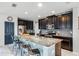 Modern kitchen with granite countertops, stainless steel appliances, and breakfast bar at 9518 Lynwood St, Clermont, FL 34711