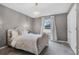 Serene main bedroom with a luxurious upholstered bed, carpet flooring, soft lighting, and a bright window at 9518 Lynwood St, Clermont, FL 34711