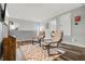 Cozy sitting area with hardwood floors, natural light, comfortable seating, and decorative wall art at 9518 Lynwood St, Clermont, FL 34711