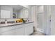 Bathroom with double sink vanity, neutral countertop, framed mirror, and bright shower at 1074 Clay Blvd, Tavares, FL 32778