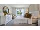 Relaxing bedroom with large window bringing in natural light, complemented by soft curtains and neutral tones at 1074 Clay Blvd, Tavares, FL 32778