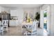 Charming dining area with a white table and chairs, stainless steel refrigerator and a sliding glass door at 1074 Clay Blvd, Tavares, FL 32778