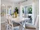 Bright dining room with a white table, seating for six, and sliding glass doors to the outdoor patio at 1074 Clay Blvd, Tavares, FL 32778