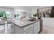 Kitchen island featuring stainless steel dishwasher and sink overlooking living and dining areas at 1074 Clay Blvd, Tavares, FL 32778