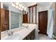 Bathroom featuring a dual sink vanity, a light fixture, and a bathtub with blue tile surround at 109 Crestwood Dr, Longwood, FL 32779