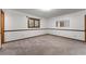 This bedroom features neutral carpet, a window, and a mirror at 109 Crestwood Dr, Longwood, FL 32779