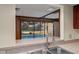 Stainless steel sink with a view of the screened-in pool and outdoor space at 109 Crestwood Dr, Longwood, FL 32779