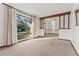 Bright, airy living room featuring neutral carpet, wood trim, and large window at 109 Crestwood Dr, Longwood, FL 32779