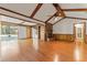 Open living room featuring a brick fireplace, wood-paneled walls, and views of the backyard pool at 109 Crestwood Dr, Longwood, FL 32779