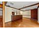 Open layout showcasing the hardwood floors, brick accents, and a seamless transition to the kitchen at 109 Crestwood Dr, Longwood, FL 32779