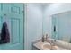 Bathroom featuring a turquoise accent door, vanity with sink, and neutral wall paint at 11595 Sw 134 Ct, Dunnellon, FL 34432