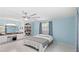 Bedroom with pastel blue walls, gray accents, and custom built-in shelving at 11595 Sw 134 Ct, Dunnellon, FL 34432