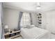 Bright bedroom featuring light gray walls, built-in shelves, and a large window at 11595 Sw 134 Ct, Dunnellon, FL 34432