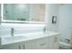 Bright bathroom with double vanity, a large LED mirror and white quartz countertops at 122 Vista Verdi Cir # 216, Lake Mary, FL 32746