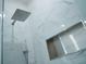 Close up of tiled shower featuring overhead rainfall shower head and shelf at 122 Vista Verdi Cir # 216, Lake Mary, FL 32746