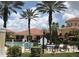 View of the community pool with lounge chairs and a clubhouse in the background at 12204 Wild Iris Way # 109, Orlando, FL 32837