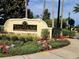 Villanova community sign surrounded by lush landscaping and mature trees on a sunny day at 12204 Wild Iris Way # 109, Orlando, FL 32837