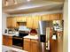 Well-lit kitchen featuring stainless steel appliances, light wood cabinetry and white countertops at 12204 Wild Iris Way # 109, Orlando, FL 32837