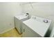 Bright laundry room features tile floors and white washer and dryer at 12204 Wild Iris Way # 109, Orlando, FL 32837