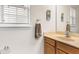 Well-lit bathroom featuring a window and a modern vanity with a wood cabinet at 13221 Fountainbleau Dr, Clermont, FL 34711