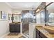 Bright bathroom showcasing dual sinks, a tiled shower with glass surround, and granite countertops at 13221 Fountainbleau Dr, Clermont, FL 34711