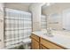 Bathroom with modern sink, mirror, and a shower curtain at 13221 Fountainbleau Dr, Clermont, FL 34711