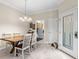 Bright dining room with a wooden table and chairs adjacent to the kitchen at 13221 Fountainbleau Dr, Clermont, FL 34711