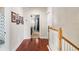 Bright hallway with hardwood floors leading to multiple rooms in the house at 13221 Fountainbleau Dr, Clermont, FL 34711