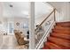 Sun-filled living room with wood stairs and comfortable seating offers an inviting space to relax at 13221 Fountainbleau Dr, Clermont, FL 34711