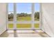 Sunny patio with a view of the green landscape through large windows at 13221 Fountainbleau Dr, Clermont, FL 34711