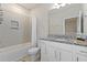 Neutral bathroom with a shower-tub combo and a granite-topped vanity at 14031 Centerline Dr, Orlando, FL 32827