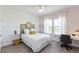 Bright bedroom featuring a bed, desk and a large window with natural light at 14031 Centerline Dr, Orlando, FL 32827