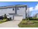 Exterior view of a two-story home with an attached garage and well-manicured landscaping at 14031 Centerline Dr, Orlando, FL 32827