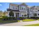 Charming two-story townhome with a blend of gray and blue siding and landscaped front yard at 14031 Centerline Dr, Orlando, FL 32827