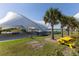 Picturesque recreation area with picnic tables, shade structure, and palm trees near the water at 14031 Centerline Dr, Orlando, FL 32827