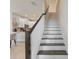 Elegant staircase with dark wood treads and white risers, adjacent to the kitchen at 14031 Centerline Dr, Orlando, FL 32827