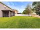 Spacious backyard featuring a white fence, well-maintained lawn and a screened porch at 14664 Spotted Sandpiper Blvd, Winter Garden, FL 34787