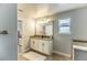 Bathroom showcasing a double vanity with granite countertops, decorative lighting, and a large mirror at 14664 Spotted Sandpiper Blvd, Winter Garden, FL 34787