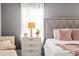 Bedroom with a tufted headboard and a nightstand with a decorative lamp at 14664 Spotted Sandpiper Blvd, Winter Garden, FL 34787